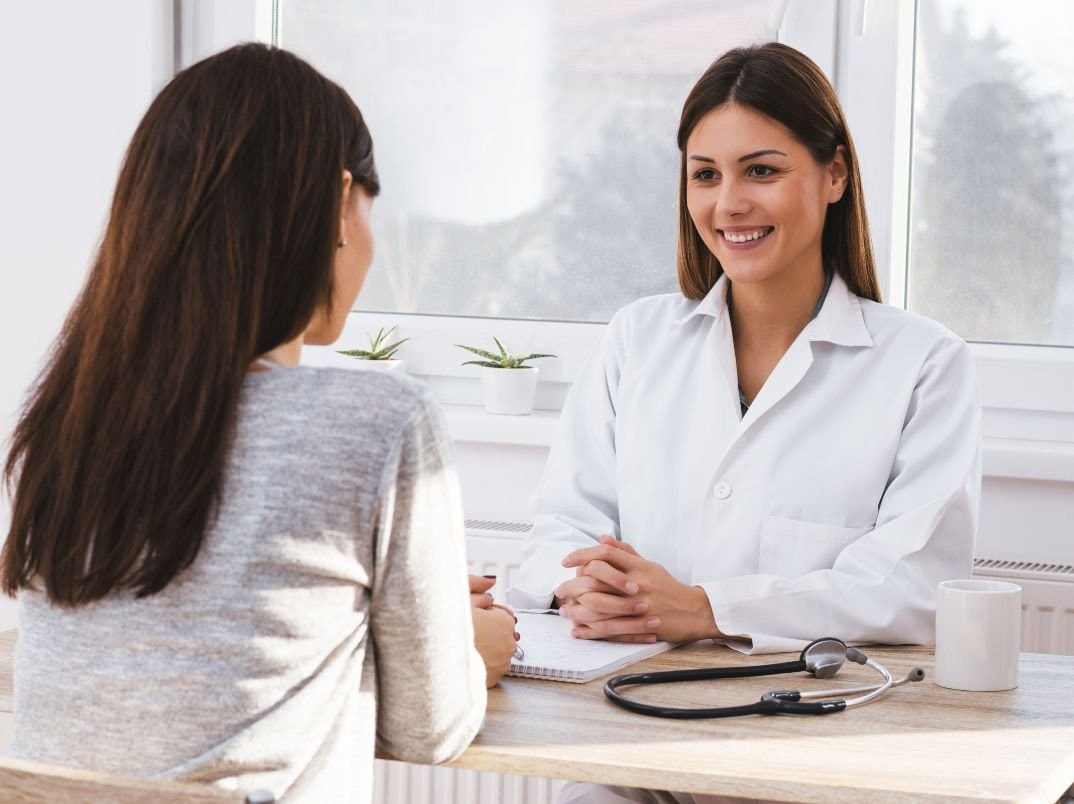 A provider and a patient in consultation in a medical office.