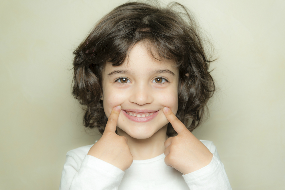A young woman with a bright, confident smile